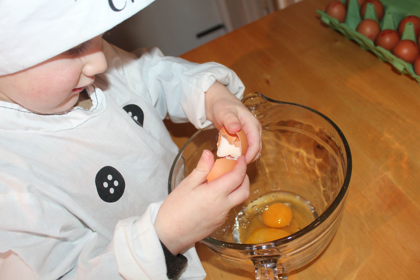 child cracking an egg